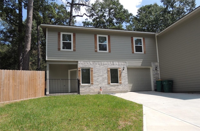 1100 Mann Rd, Conroe, TX 77303 - view of front of house with fence, an attached garage, brick siding, driveway, and a front lawn
