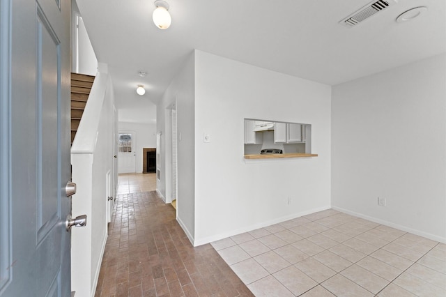 10001 Westpark Dr Unit 7, Houston, TX 77042 - foyer entrance with baseboards, stairs, a fireplace, and visible vents