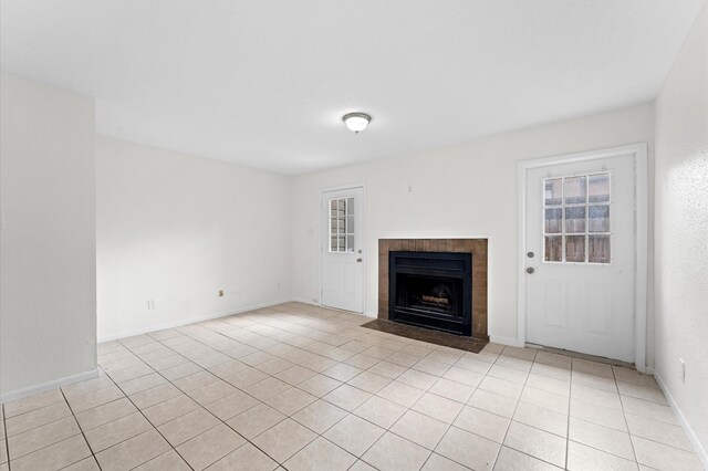 10001 Westpark Dr Unit 7, Houston, TX 77042 - unfurnished living room with light tile patterned floors, baseboards, and a fireplace with flush hearth