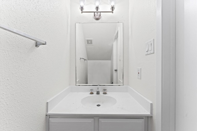 10001 Westpark Dr Unit 7, Houston, TX 77042 - bathroom featuring vanity, a textured wall, and visible vents