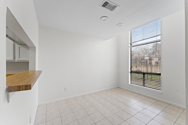 10001 Westpark Dr Unit 7, Houston, TX 77042 - unfurnished dining area with baseboards, light tile patterned floors, and visible vents