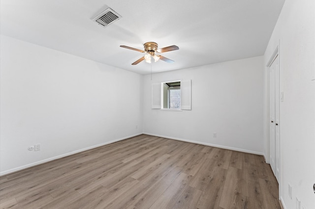 10001 Westpark Dr Unit 7, Houston, TX 77042 - empty room with a ceiling fan, baseboards, visible vents, and wood finished floors