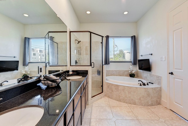 full bath with a stall shower, a sink, double vanity, and a bath