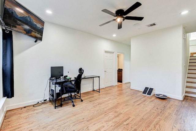 home office with a ceiling fan, baseboards, visible vents, and wood finished floors