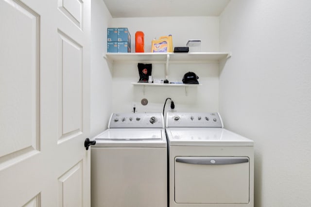 clothes washing area featuring washing machine and clothes dryer and laundry area