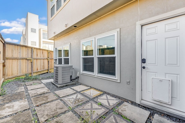 exterior space with cooling unit and fence