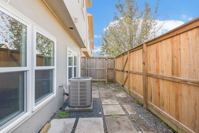 view of patio with cooling unit and a fenced backyard