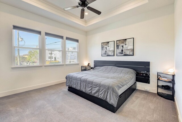 carpeted bedroom featuring a ceiling fan, recessed lighting, baseboards, ornamental molding, and a raised ceiling