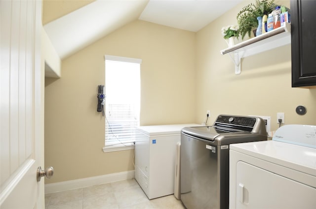 19923 Durwood Pines Ln, Cypress, TX 77433 - clothes washing area with washer and dryer, cabinet space, light tile patterned floors, and baseboards