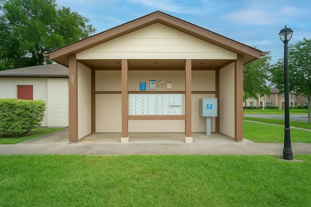 surrounding community featuring mail area and a yard