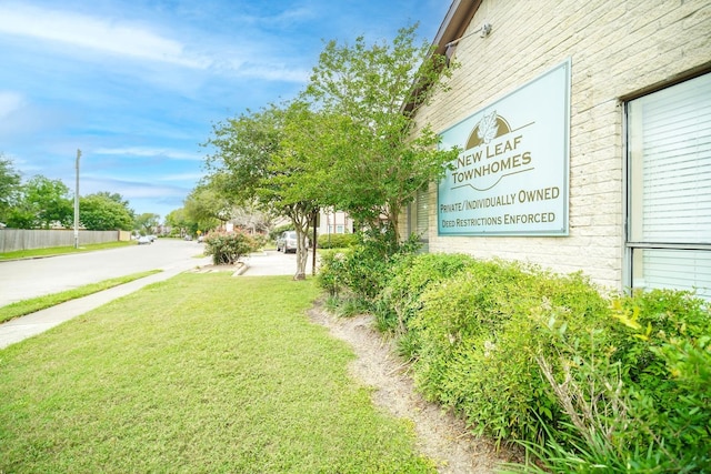 community / neighborhood sign with a lawn