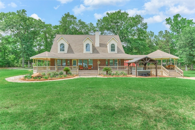 15050 Lake Paula Dr, Willis, TX 77318 - view of front of property with a hot tub, a gazebo, a chimney, covered porch, and a front yard