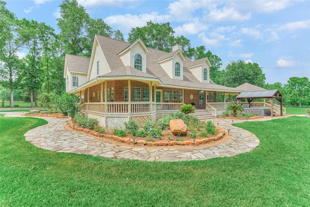 15050 Lake Paula Dr, Willis, TX 77318 - view of front of home featuring a gazebo, a chimney, a shingled roof, brick siding, and a front yard