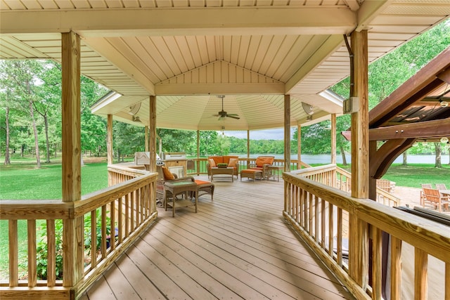 15050 Lake Paula Dr, Willis, TX 77318 - wooden deck featuring ceiling fan, a gazebo, a yard, outdoor lounge area, and view of wooded area