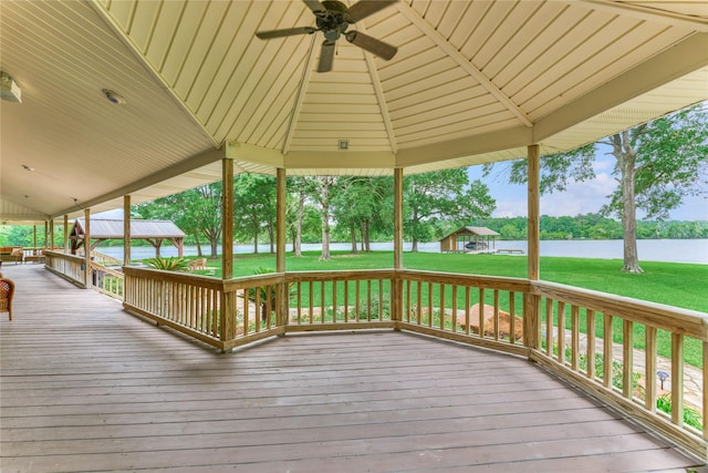 15050 Lake Paula Dr, Willis, TX 77318 - wooden terrace with a gazebo, ceiling fan, a lawn, and a water view