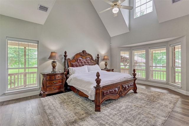15050 Lake Paula Dr, Willis, TX 77318 - bedroom with high vaulted ceiling, wood finished floors, baseboards, and ceiling fan