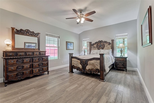 15050 Lake Paula Dr, Willis, TX 77318 - bedroom featuring baseboards, wood finished floors, lofted ceiling, and ceiling fan