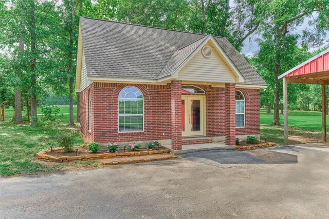 15050 Lake Paula Dr, Willis, TX 77318 - view of front of property featuring roof with shingles, brick siding, and a front yard