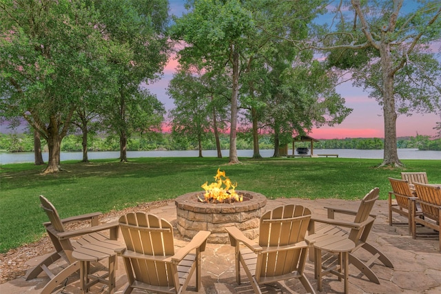15050 Lake Paula Dr, Willis, TX 77318 - view of patio with a fire pit and a water view