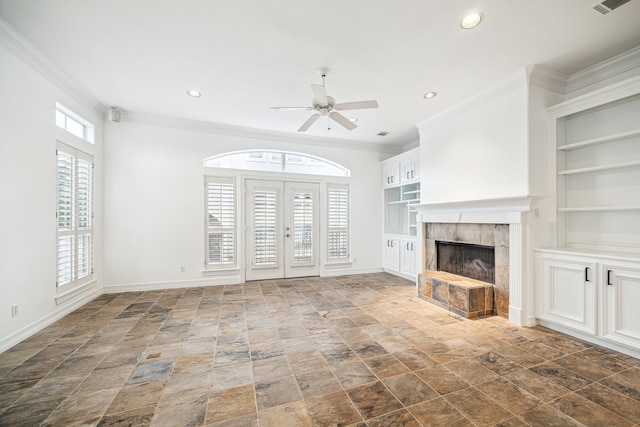unfurnished living room with ornamental molding, baseboards, a ceiling fan, and built in features