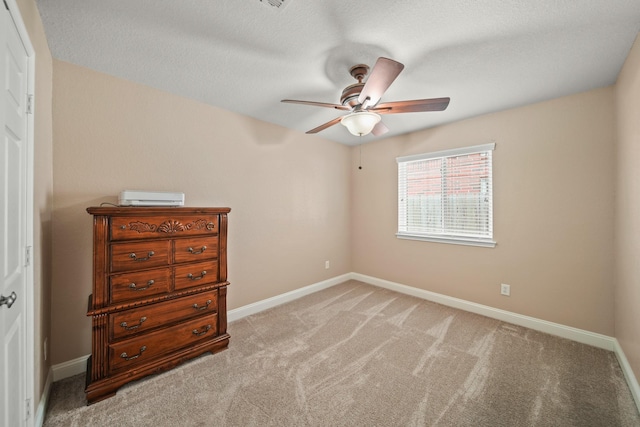 bedroom featuring light colored carpet, baseboards, and a ceiling fan