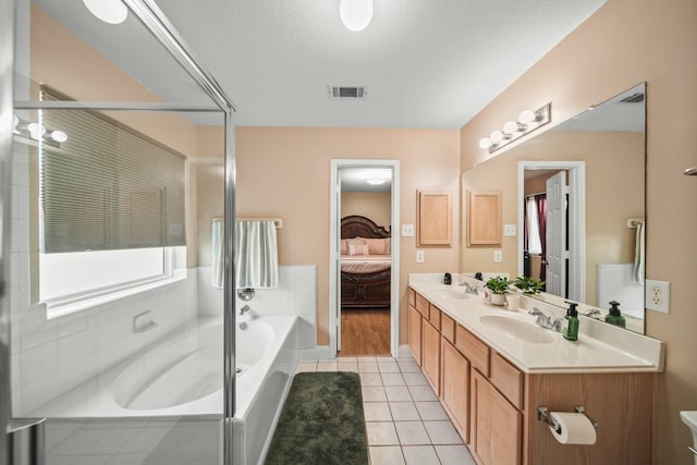 ensuite bathroom with a sink, ensuite bath, visible vents, tile patterned flooring, and a bath