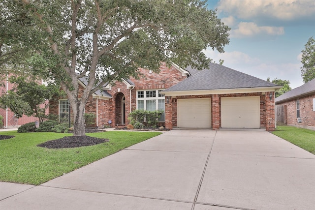 view of front of house featuring concrete driveway, a front yard, roof with shingles, and an attached garage