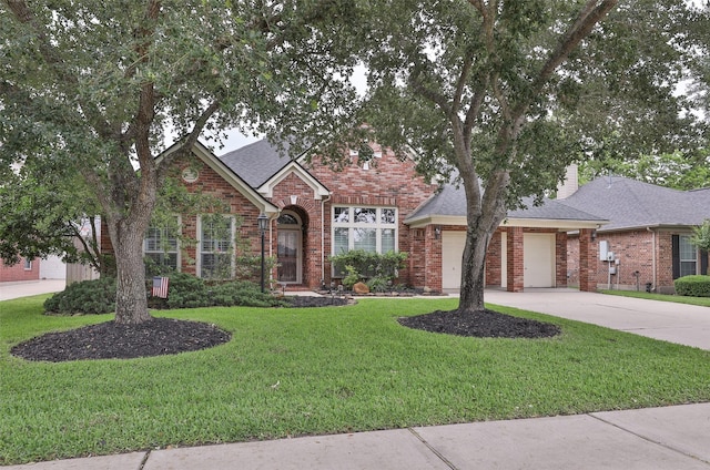 traditional home featuring brick siding, concrete driveway, a garage, a front yard, and a shingled roof