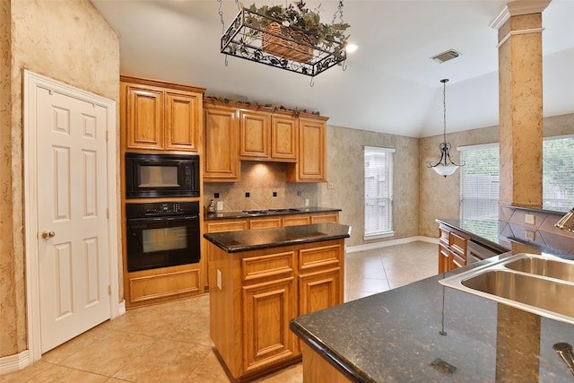 kitchen featuring vaulted ceiling, a sink, visible vents, black appliances, and a kitchen island