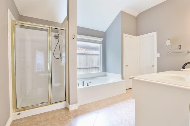 bathroom featuring a shower stall, tile patterned floors, a garden tub, and vaulted ceiling