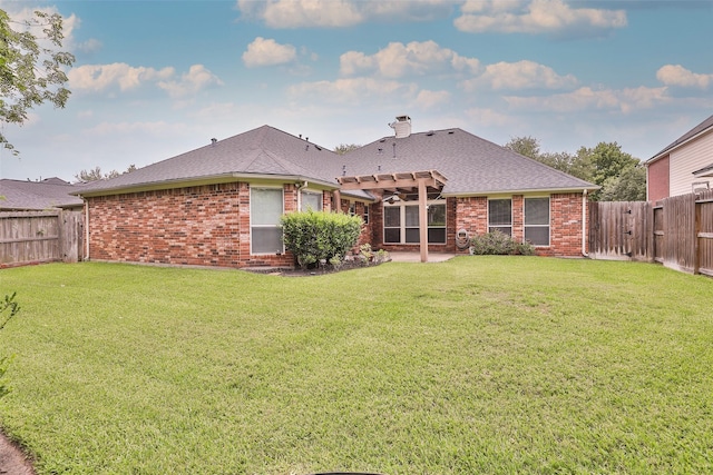 back of property featuring a yard, a pergola, brick siding, and a fenced backyard