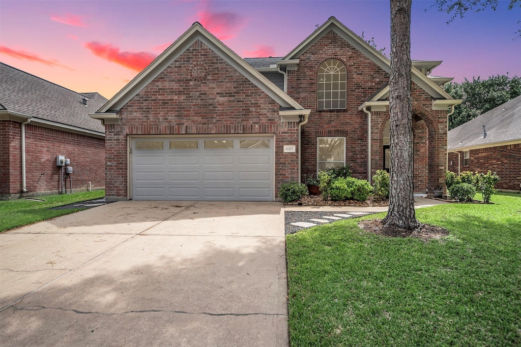 6327 Clear Canyon Dr, Katy, TX 77450 - traditional-style home with concrete driveway, a garage, brick siding, and a front lawn