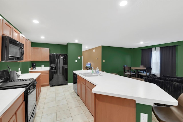 4826 Westfield Pines Dr, Katy, TX 77449 - kitchen featuring black appliances, a sink, light countertops, a kitchen island, and recessed lighting