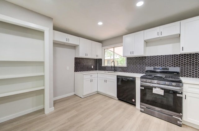 kitchen featuring a sink, black dishwasher, stainless steel gas stove, decorative backsplash, and white cabinets