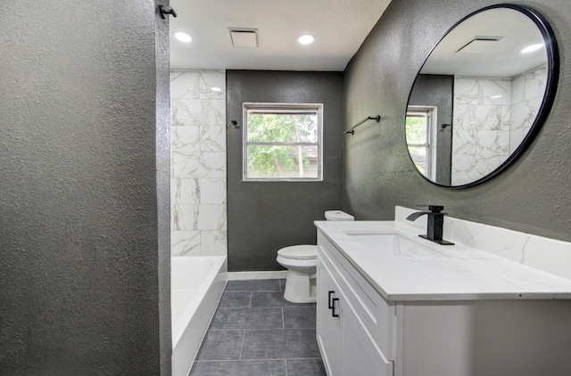 bathroom featuring toilet, tile patterned flooring, vanity, and a textured wall