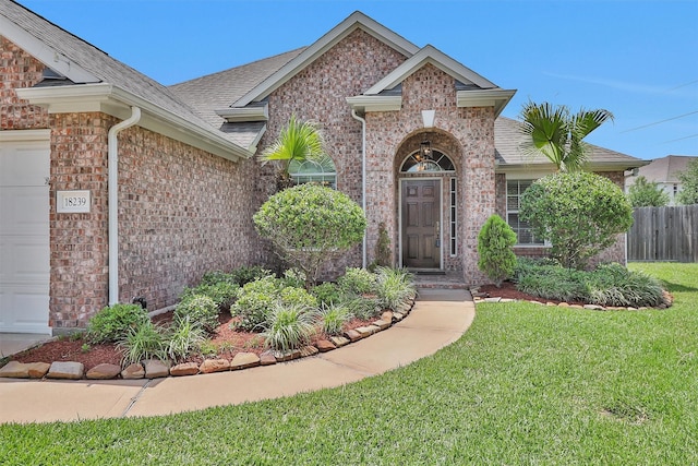 18239 Rustic Springs Dr, Tomball, TX 77375 - doorway to property with a garage and brick siding