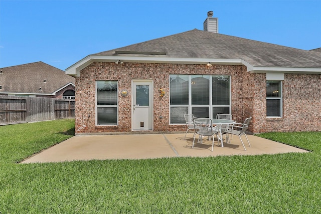 18239 Rustic Springs Dr, Tomball, TX 77375 - back of house featuring brick siding, a patio, a chimney, and roof with shingles