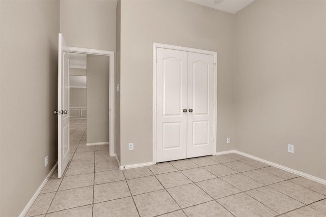 18239 Rustic Springs Dr, Tomball, TX 77375 - unfurnished bedroom featuring light tile patterned flooring, baseboards, and a closet