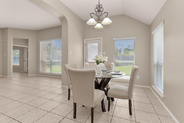 18239 Rustic Springs Dr, Tomball, TX 77375 - dining space with light tile patterned floors, a chandelier, plenty of natural light, arched walkways, and lofted ceiling