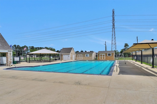 18239 Rustic Springs Dr, Tomball, TX 77375 - community pool with fence, a gazebo, an outdoor structure, and a patio area