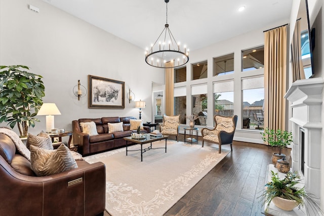 1614 Primrose Ln, Katy, TX 77493 - living area featuring dark wood-style flooring, a chandelier, a towering ceiling, and recessed lighting