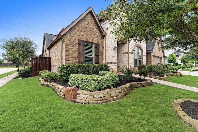 1614 Primrose Ln, Katy, TX 77493 - view of front facade with brick siding, a front lawn, and roof with shingles