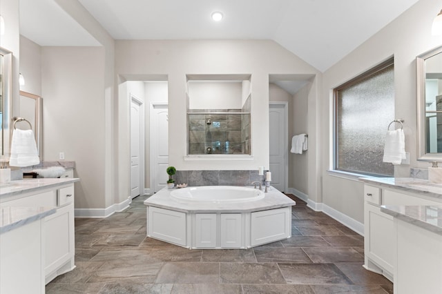 1614 Primrose Ln, Katy, TX 77493 - full bathroom with tiled shower, a bath, baseboards, stone finish floors, and lofted ceiling