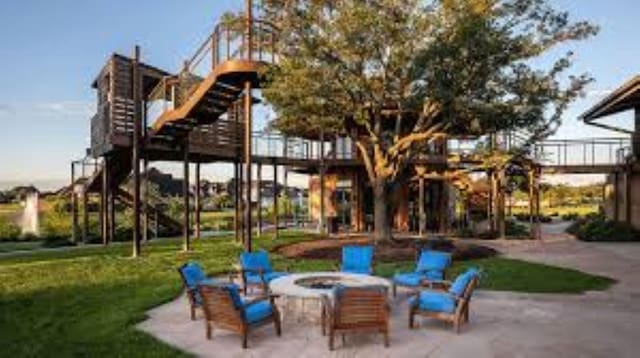 1614 Primrose Ln, Katy, TX 77493 - view of play area featuring an outdoor fire pit, a yard, a patio area, and stairway