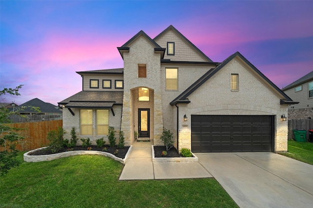 french country inspired facade with a yard, fence, brick siding, and driveway