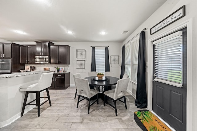 dining room with baseboards, visible vents, and recessed lighting