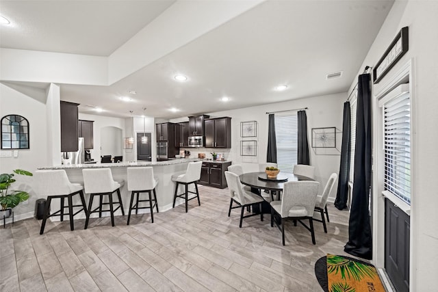 dining room with light wood-style floors, visible vents, baseboards, and recessed lighting
