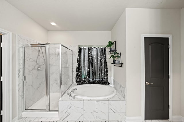 full bathroom featuring a garden tub and a stall shower
