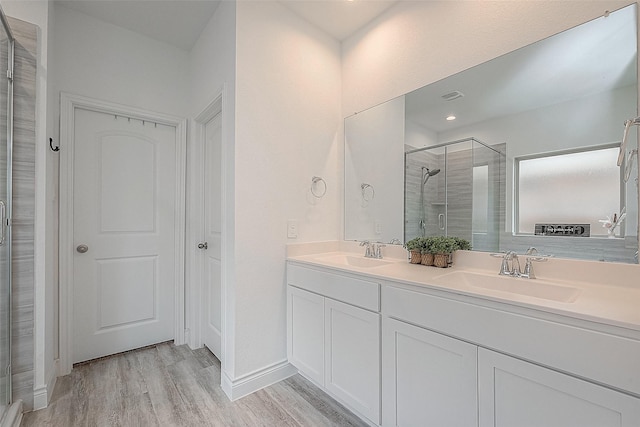 1672 Happy Valley St, Montgomery, TX 77316 - bathroom featuring double vanity, wood finished floors, a shower stall, and a sink