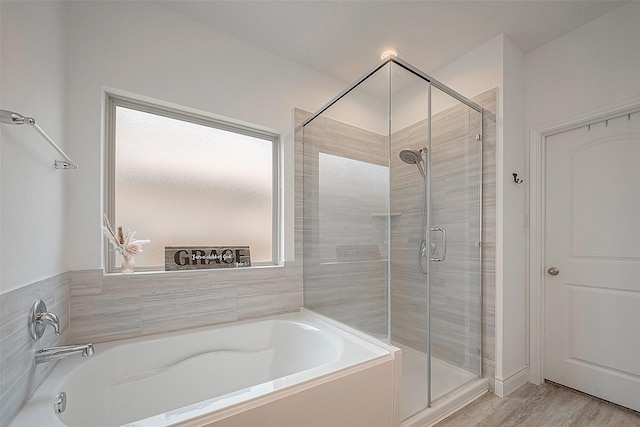 1672 Happy Valley St, Montgomery, TX 77316 - full bathroom with a stall shower, a wealth of natural light, a bath, and wood finished floors